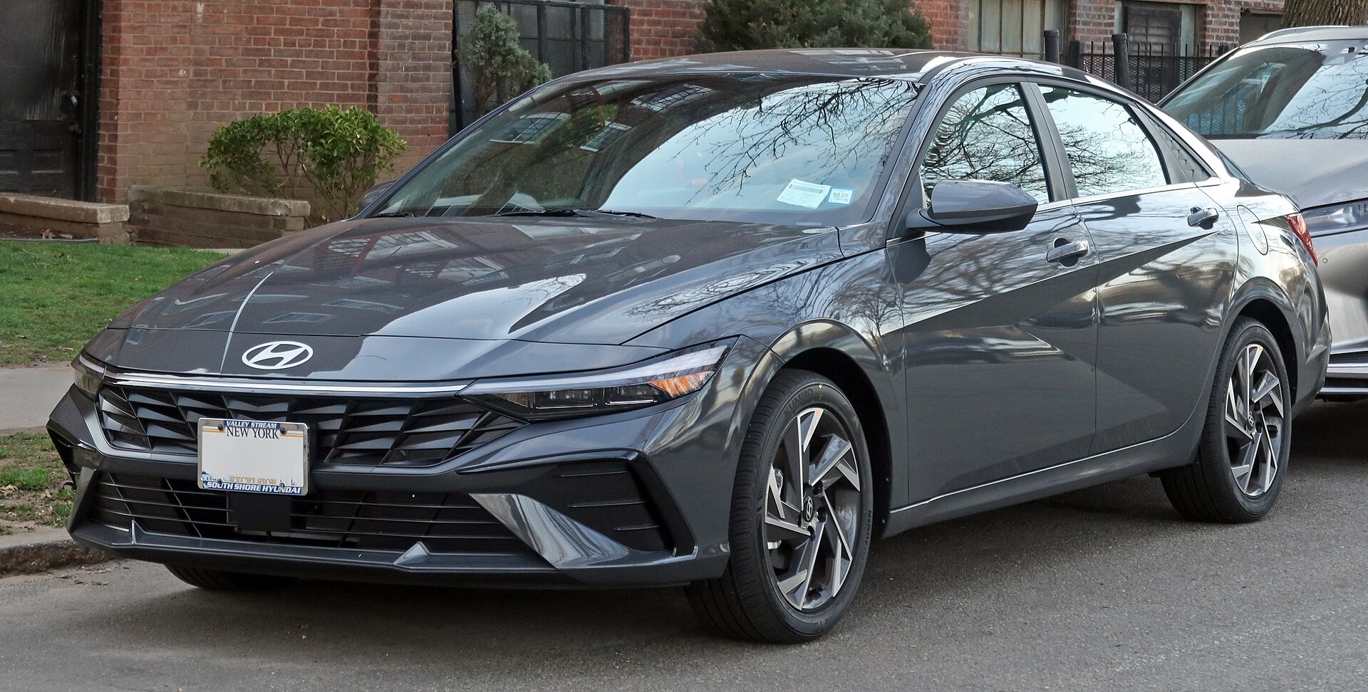 Amazon Gray 2026 Hyundai Elantra North American sedan viewed from the front three-quarter angle