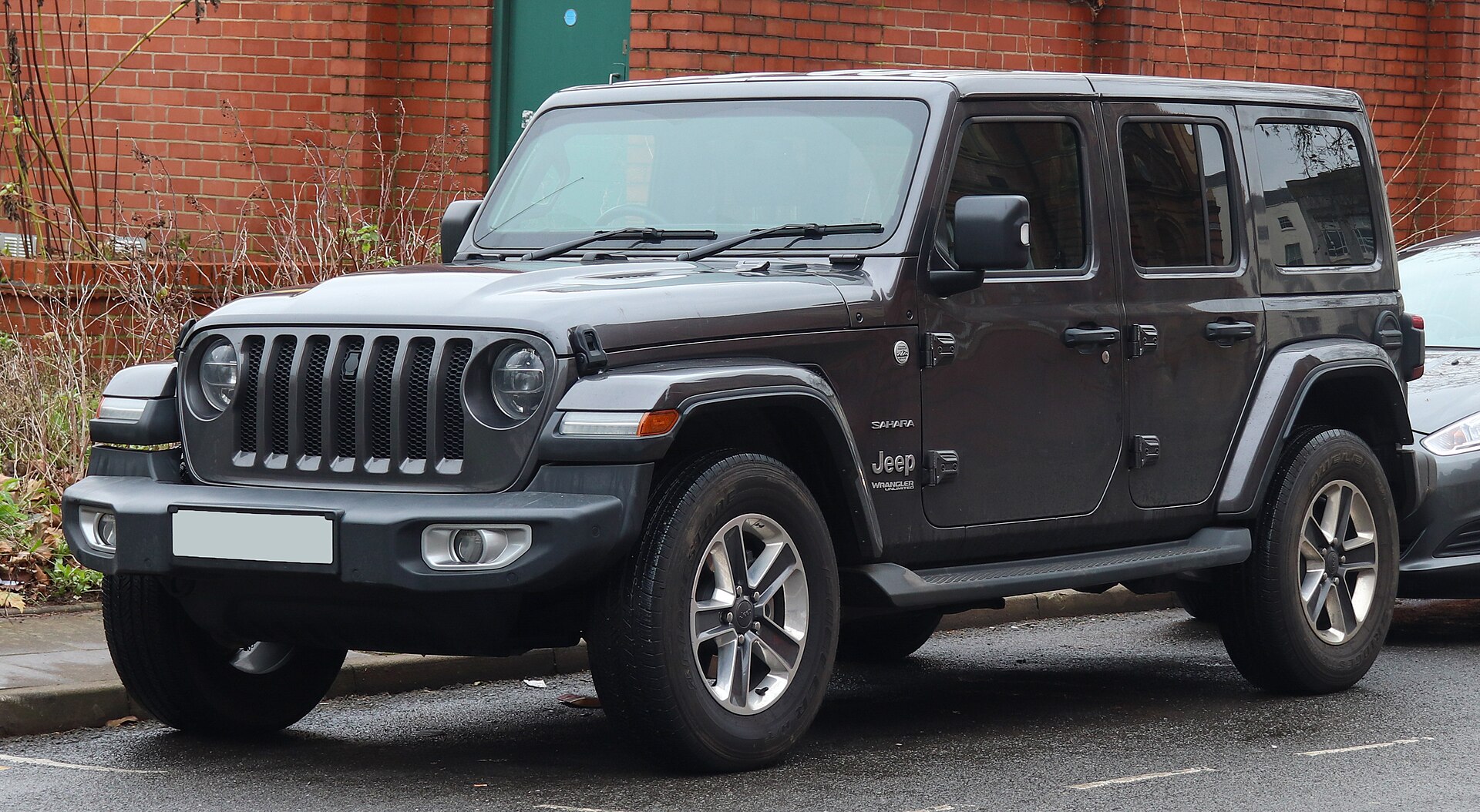 Gasoline 2026 Jeep Wrangler four-door in an official front three-quarter exterior view